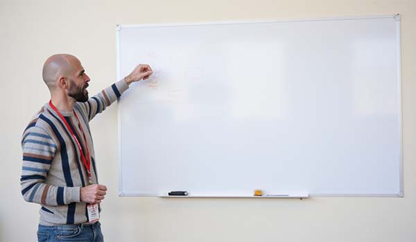 Álvaro Torres dibujando en una pizarra un mapa simple de escenarios de respuesta en redes